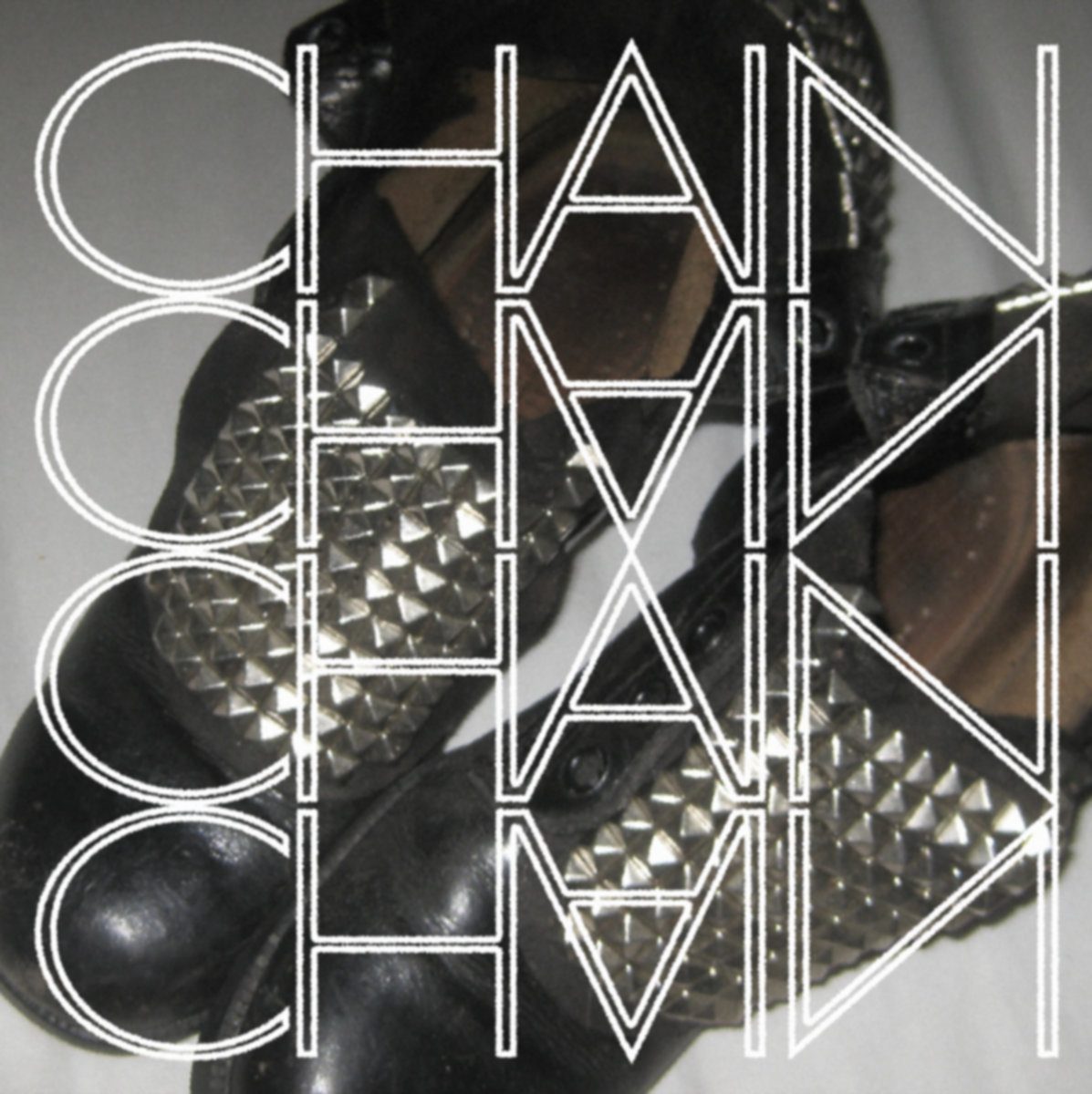 Chain cover: studded black leather boots under the word CHAIN in thin outlined capitals, repeated and mirrored four times