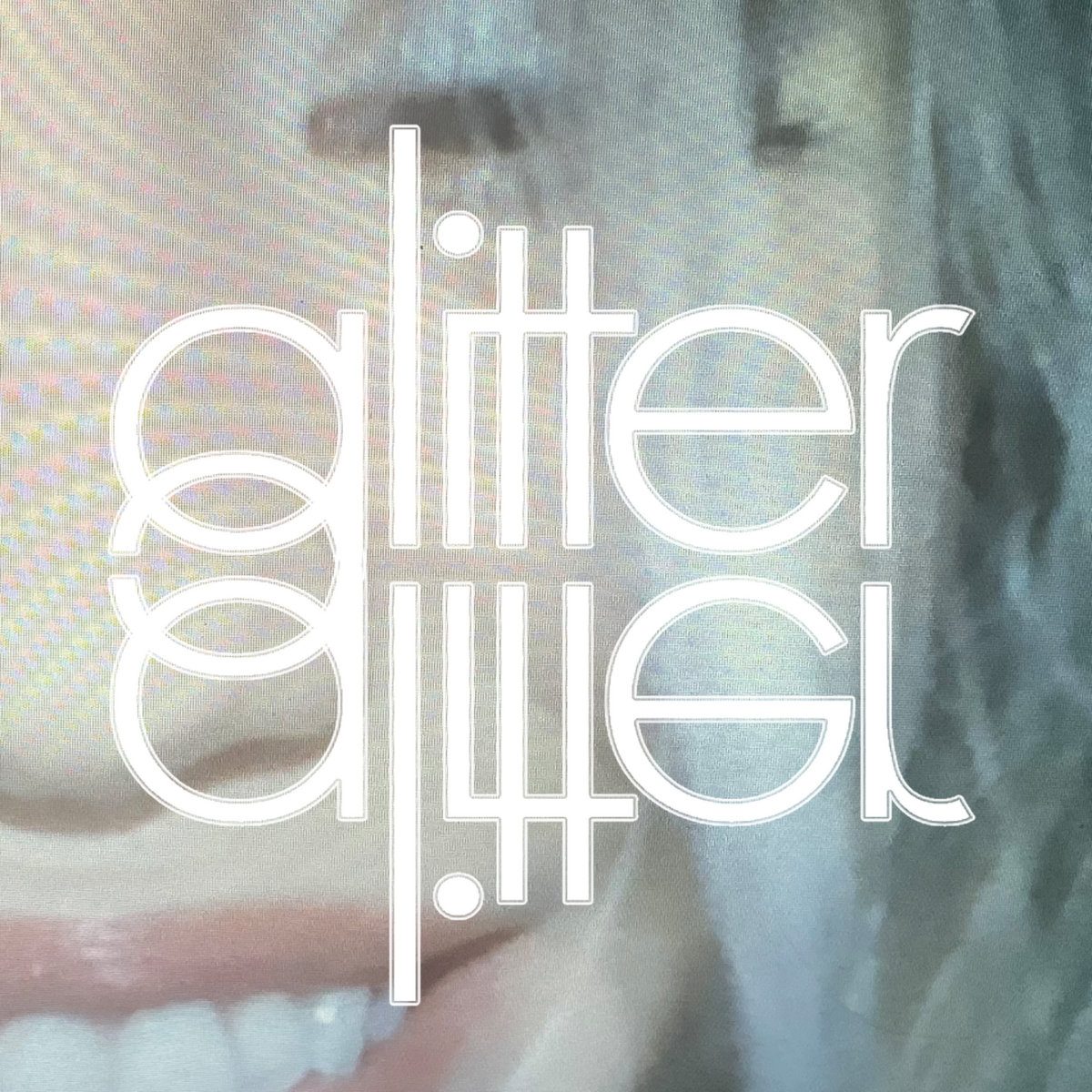 Glitter cover: a smiling mouth in pastel haze behind the word glitter in thin outlined letters, mirrored beneath itself