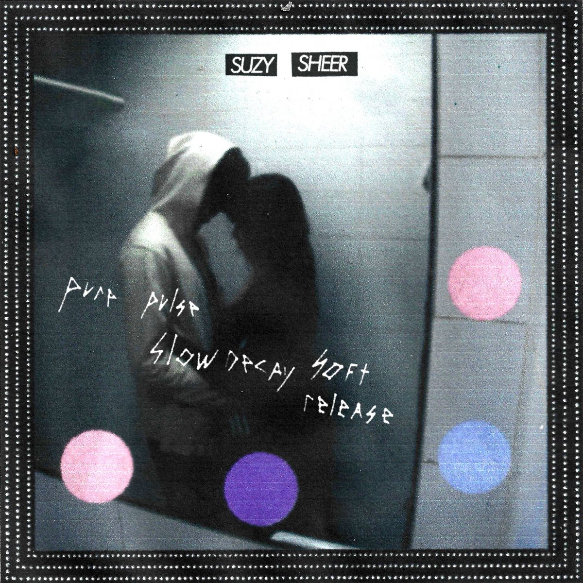 Pure Pulse, Slow Decay, Soft Release cover: a hooded couple embracing in a grey stairwell, hand-scratched title, pink, violet and periwinkle dots, a dotted film-strip border and small SUZY SHEER labels
